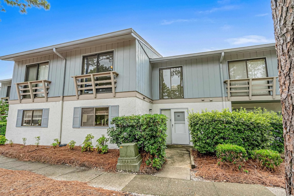 View of front of property with a balcony