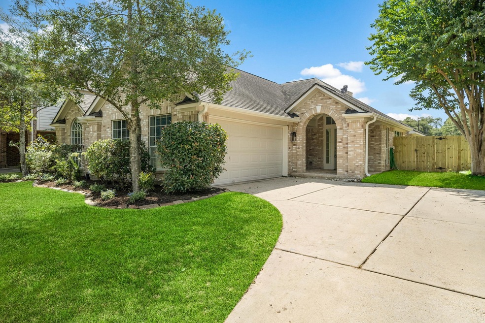 Curved driveway leads to the garage and front door.