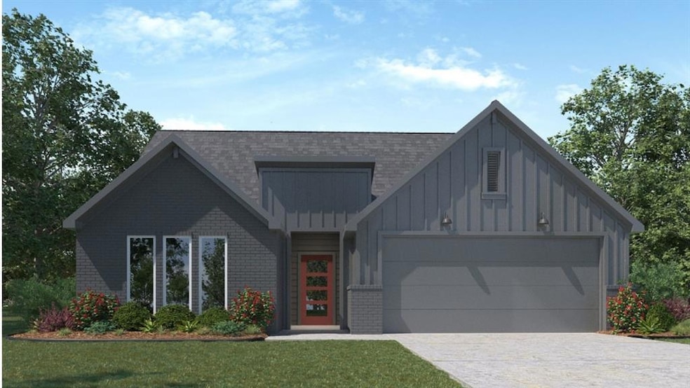 View of front of property featuring board and batten siding, brick siding, driveway, and a front lawn