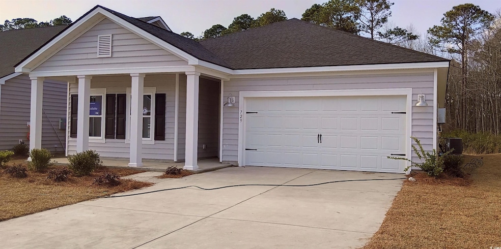 View of front of house with a garage, a porch, and