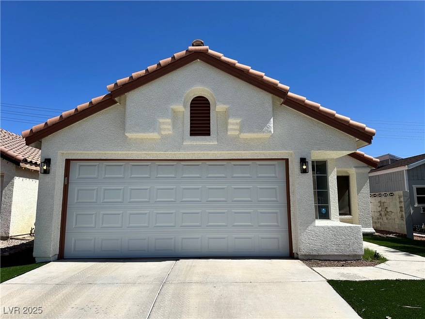 View of front of home with a tiled roof, stucco si