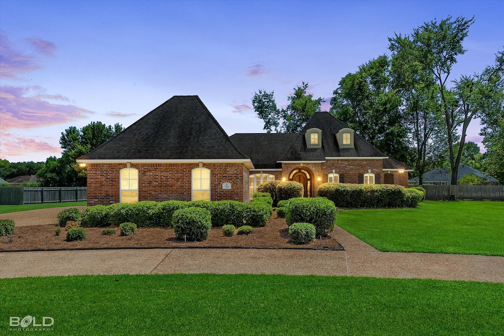 View of front of property featuring brick siding and a shingled roof