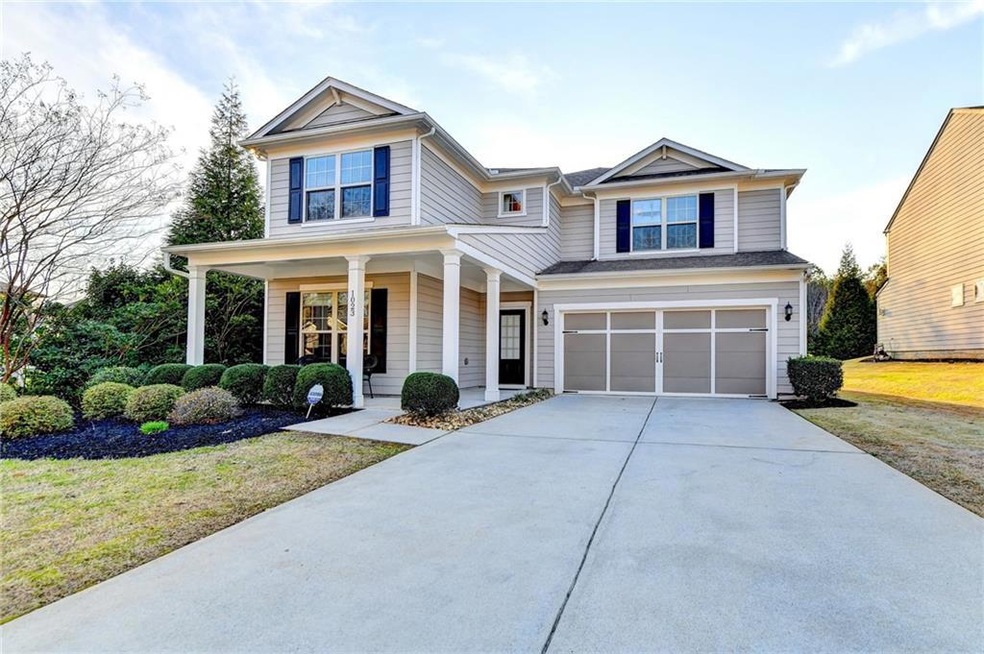 View of front of home with a front lawn, a garage,