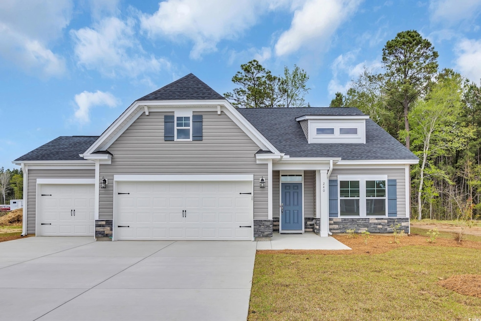 View of front of house featuring driveway, stone s