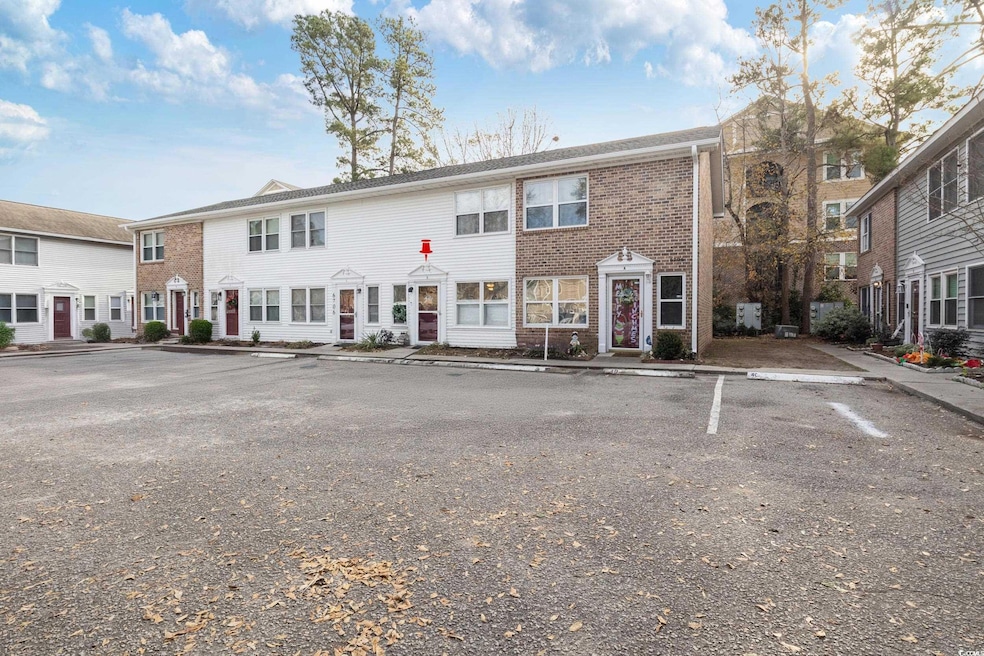 View of front facade with uncovered parking and br