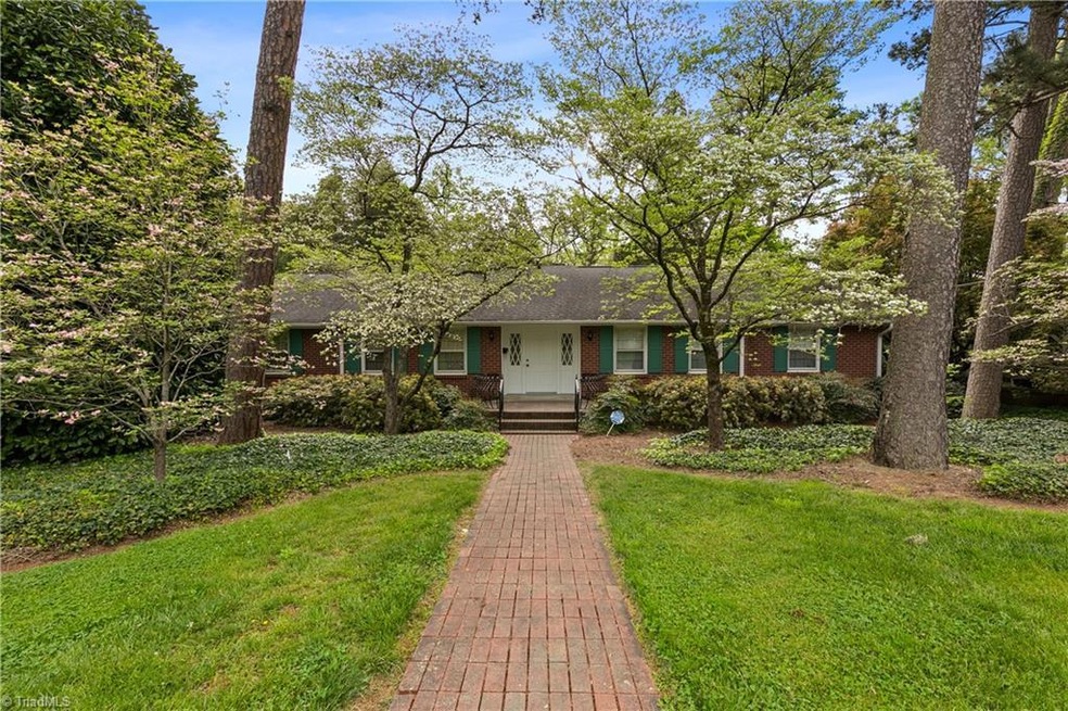 Long brick sidewalk leads you to the front door.