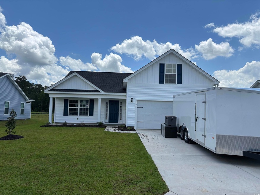 View of front of house with concrete driveway, boa
