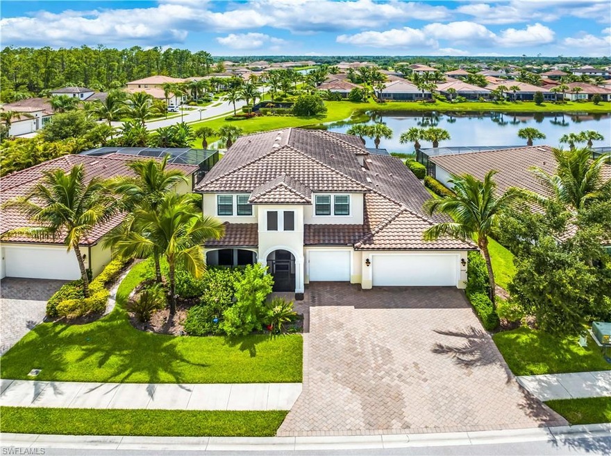 Aerial view of the home with lake views