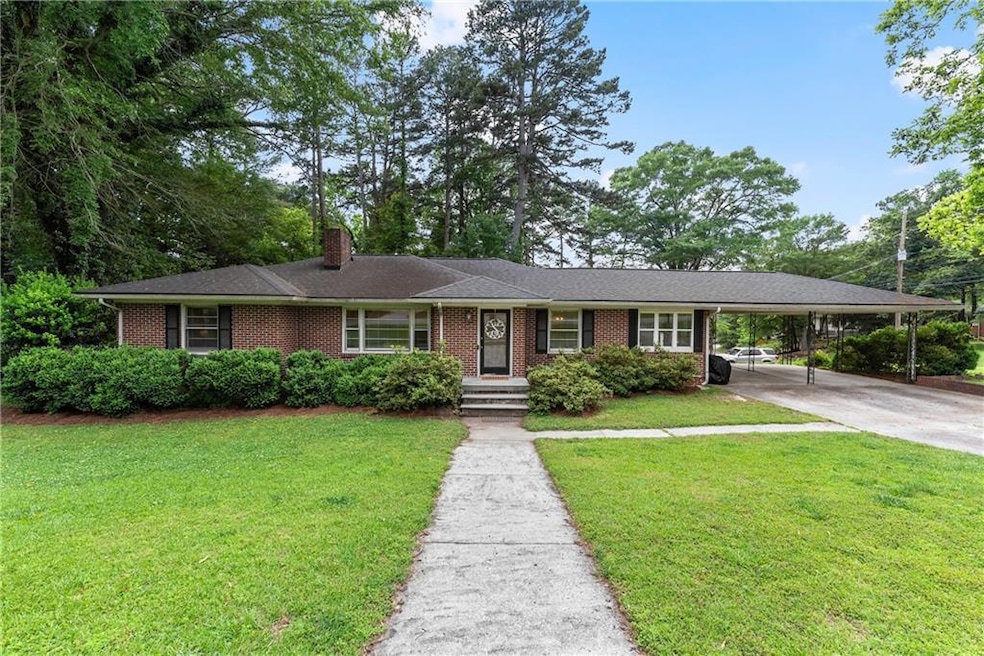 Ranch-style house with brick siding, a chimney, a 