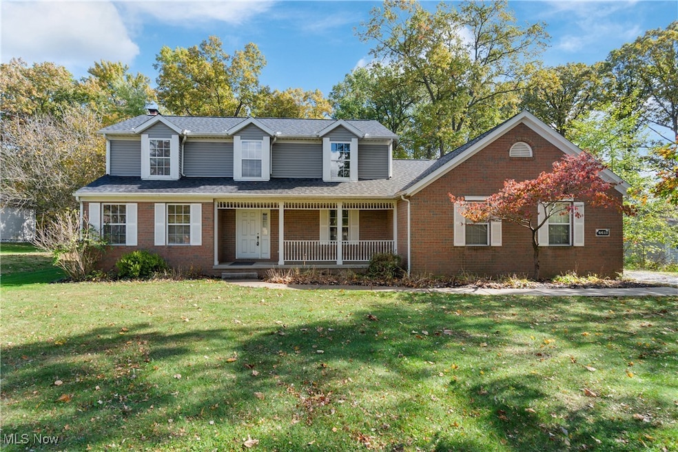 Traditional-style house featuring covered porch, a front yard, and brick siding