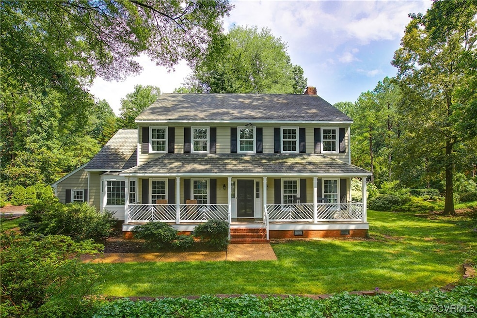 Colonial inspired home featuring covered porch, a