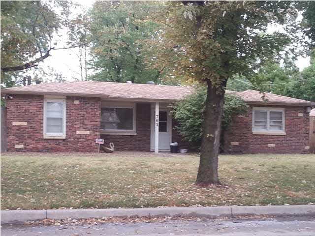 Close up view of the all brick home.