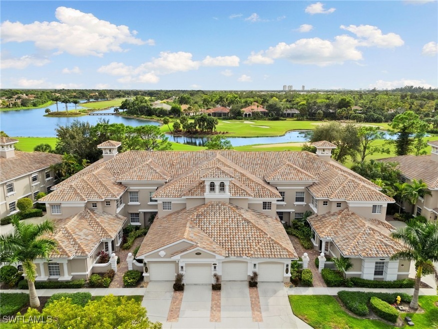Aerial perspective of suburban area featuring a large body of water and a tree filled landscape