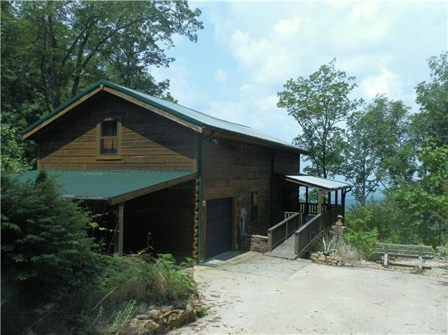 Custom built log cabin on 2.64 acres of Bluff front property