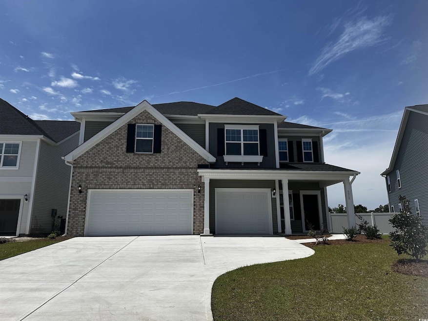 View of front of home with driveway, a garage, and