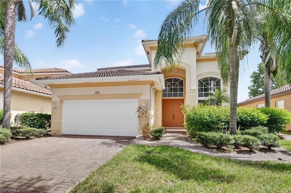 Mediterranean / spanish-style house featuring stucco siding, a garage, decorative driveway, and a tiled roof