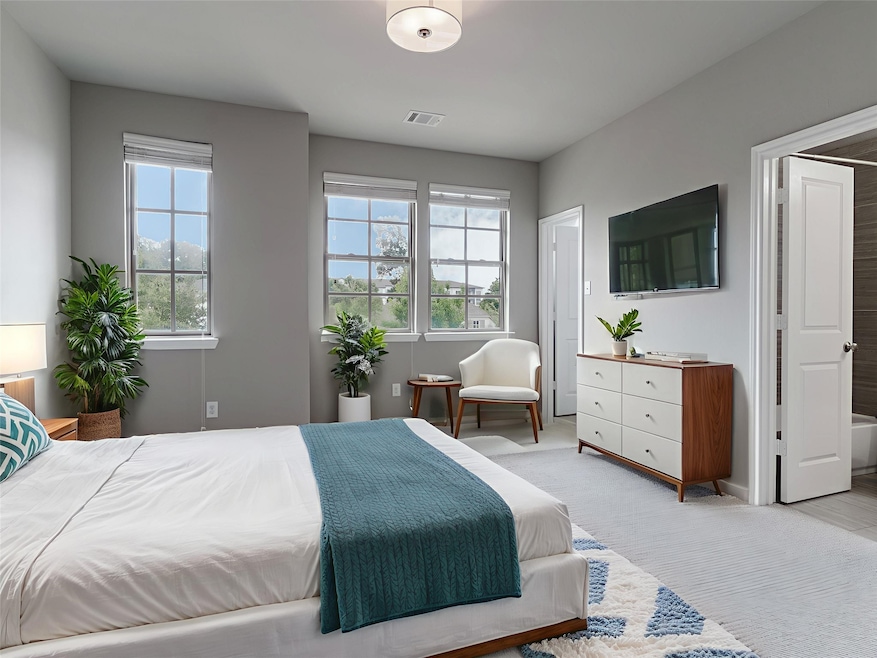 Carpeted bedroom featuring multiple windows