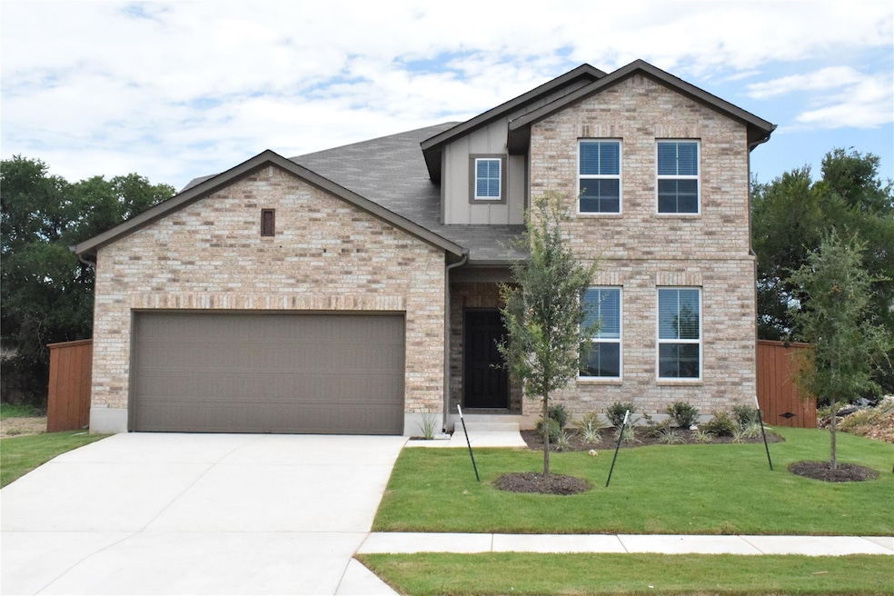 View of front facade with driveway, an attached g