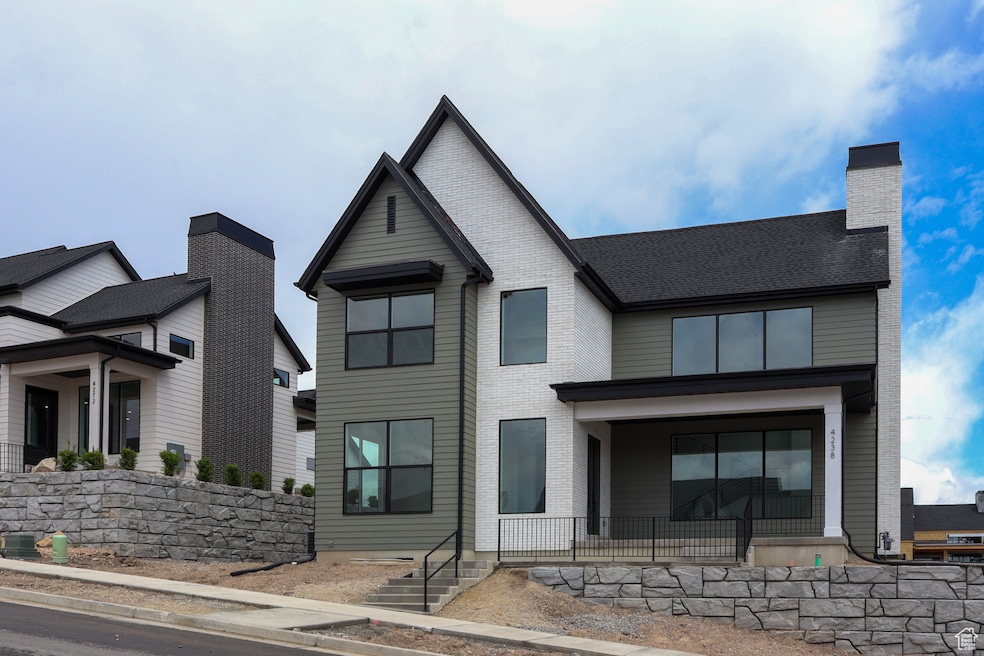 View of front facade with brick siding and a chimney