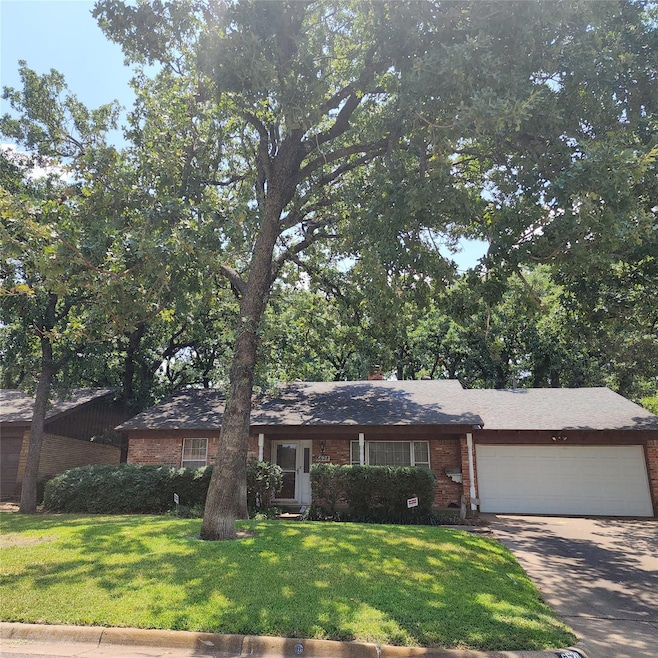 Single story home with a garage and a front yard