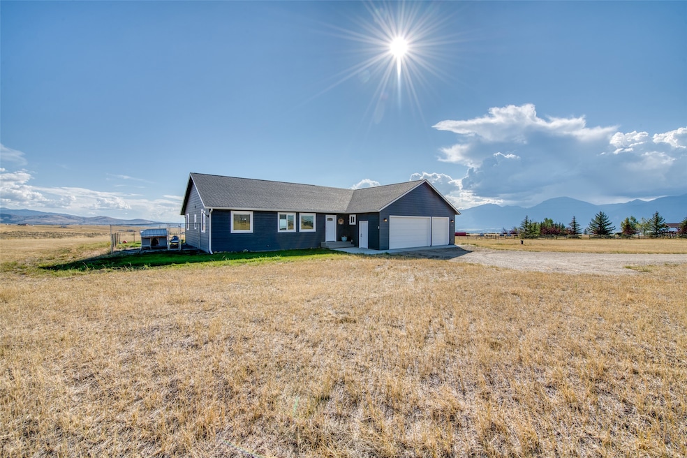 Single story home with a mountain view, driveway, a front yard, and an attached garage