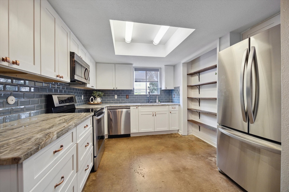 Bright and open kitchen with updated counters, bac
