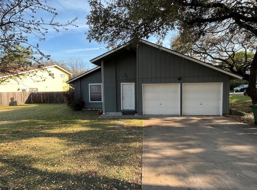 View of front of home with a front yard, fence, a