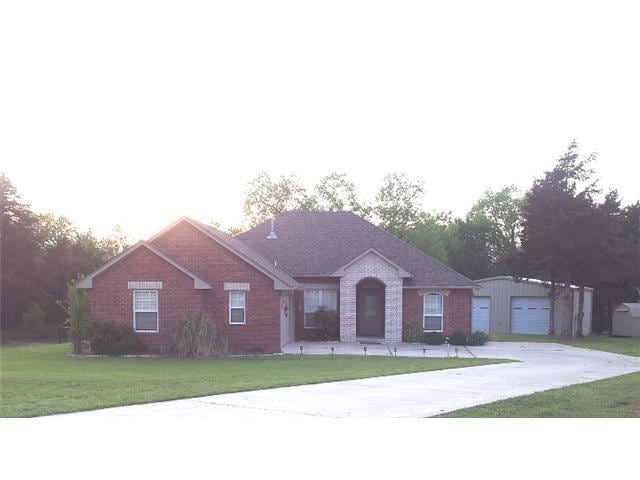 Exterior Front. Beautiful custom home nested in a great lot of trees in a wonderful neighborhood.