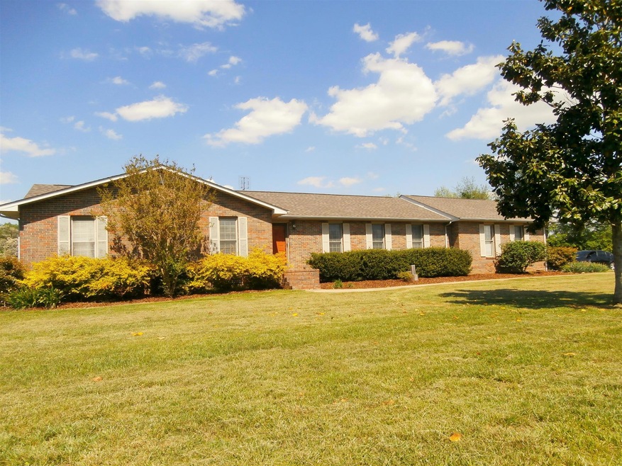 FRONT OF HOME FEATURING NEW ROOF, LOW MAINTENANCE LANDSCAPING & WELCOMING ENTRY