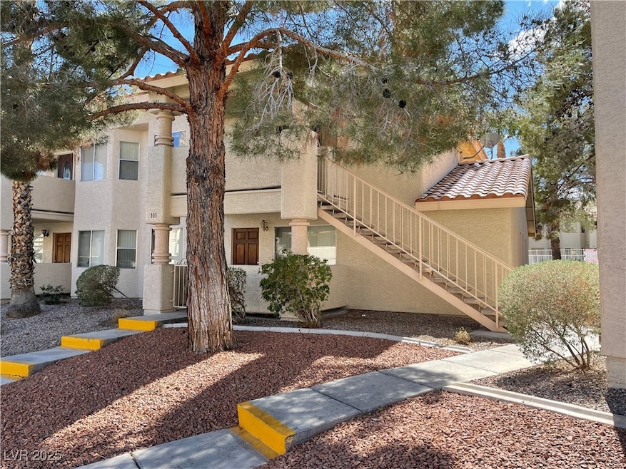 View of front of property with stucco siding, stai