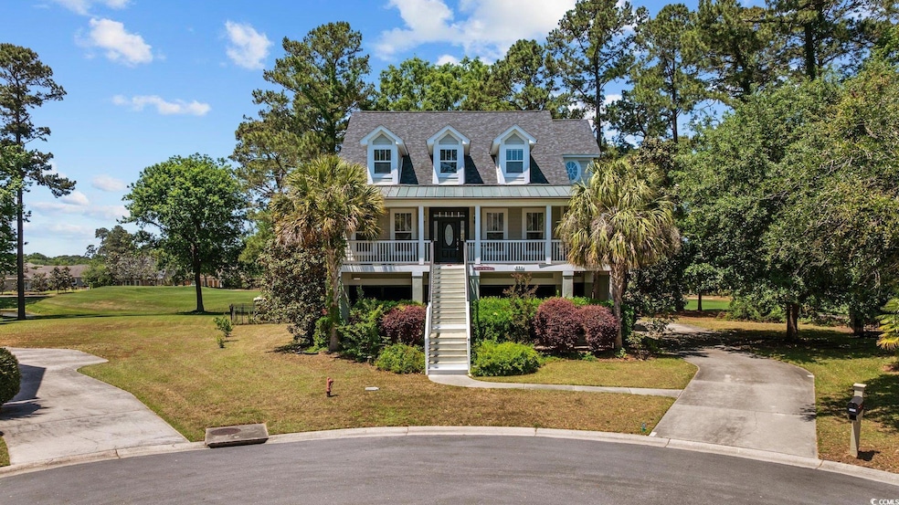 View of front of home with stairs, covered porch, 