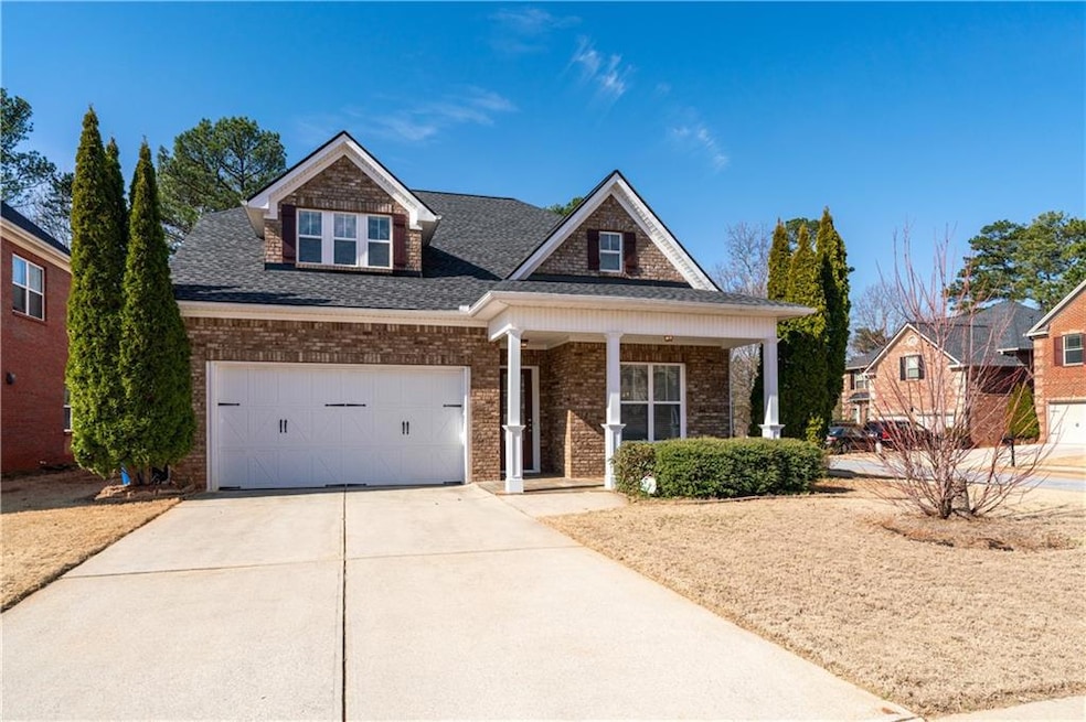 Craftsman-style house with brick siding, a porch, 