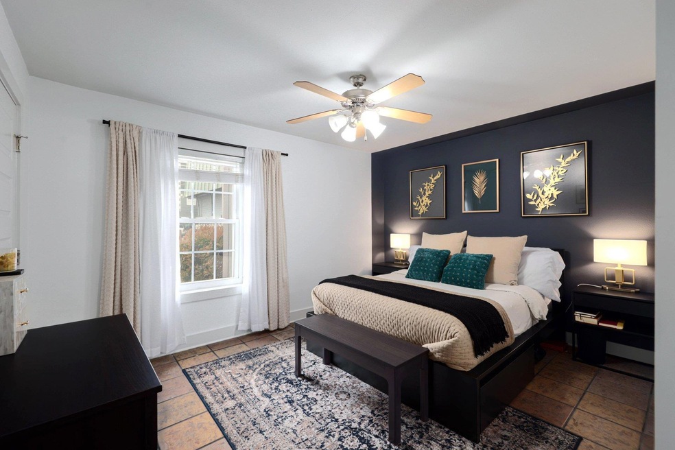 Bedroom with ceiling fan and baseboards