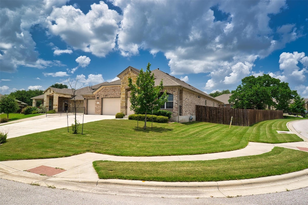 View of front facade featuring a garage, driveway