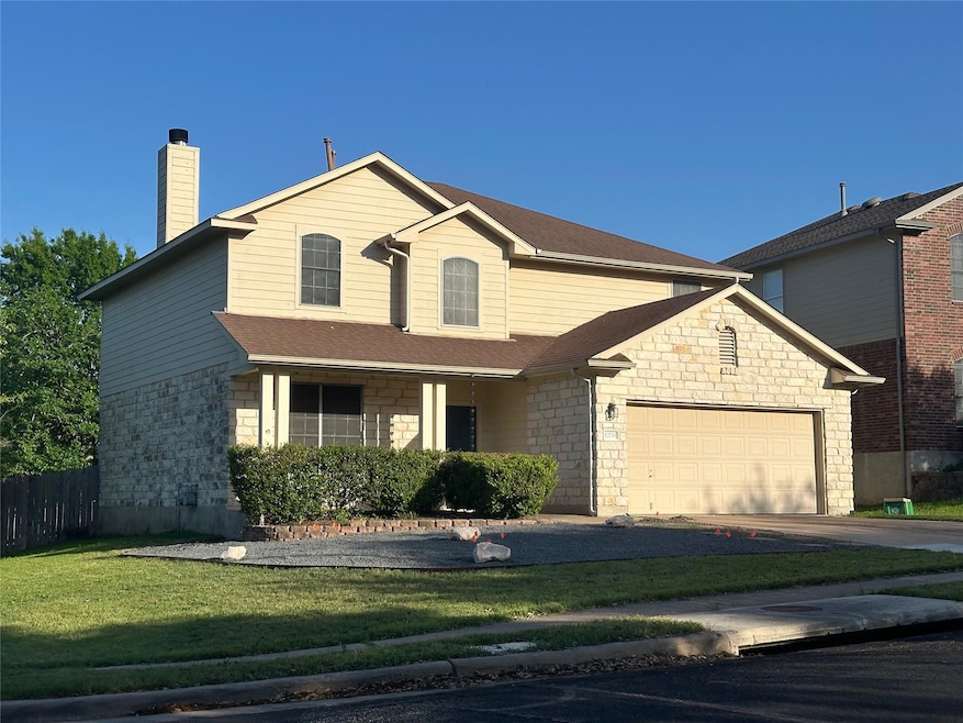 Traditional-style house featuring stone siding, a