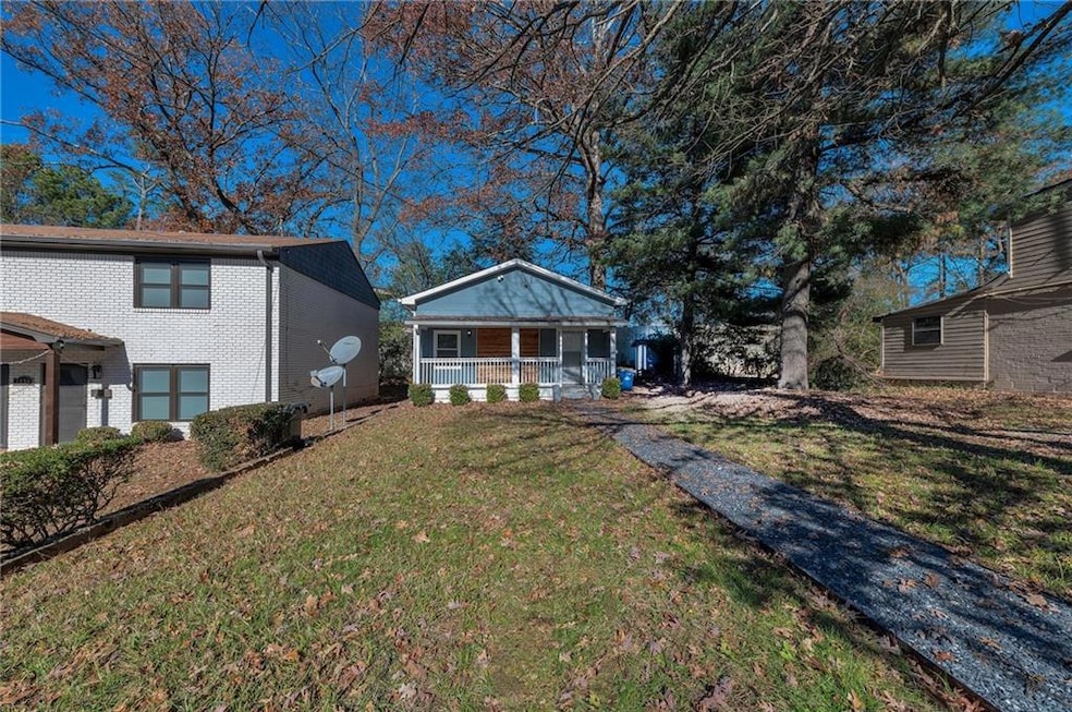 View of front of property featuring a front yard and covered porch