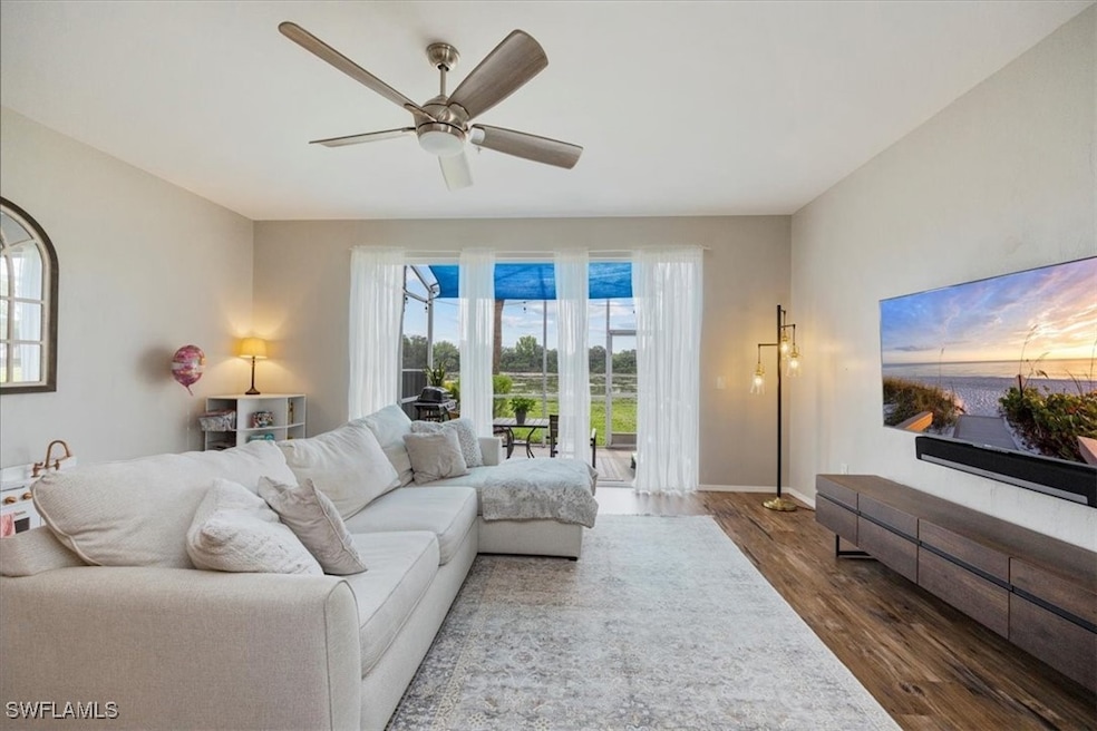Living room with wood finished floors, a ceiling f
