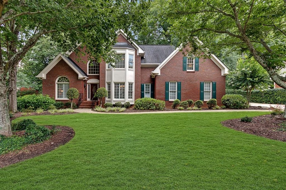 Three and a half sided brick home with a level dri