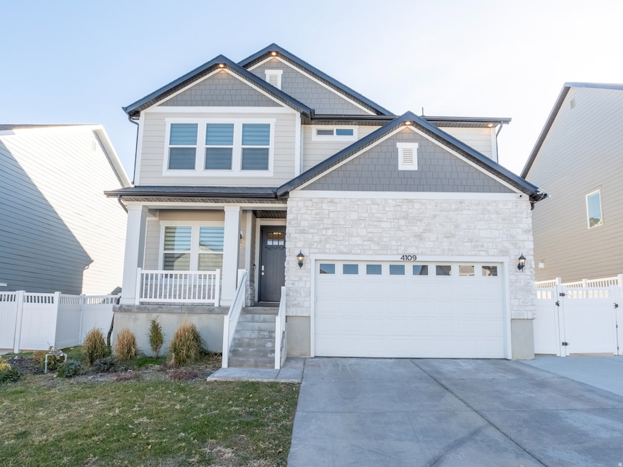 View of front of home featuring driveway, an attached garage, and a gate