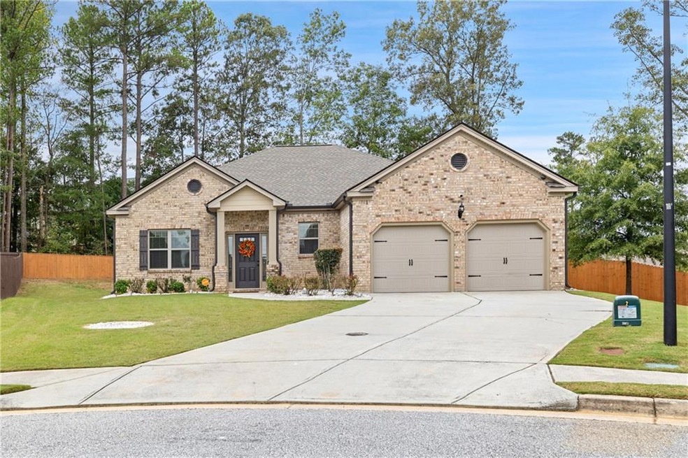 View of front of house with a garage and a front y