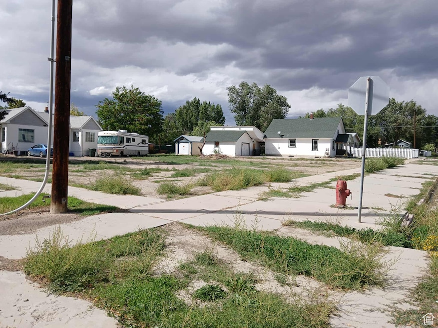 View of yard featuring an outbuilding, driveway, and a residential view