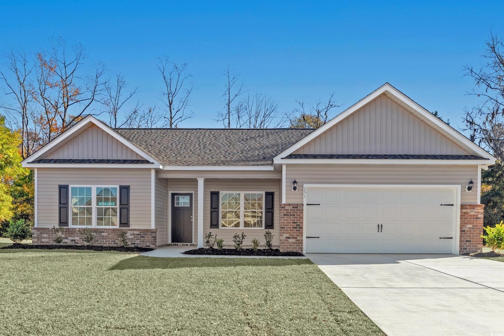 View of front of house with brick siding, board and batten siding, covered porch, a front lawn, and driveway