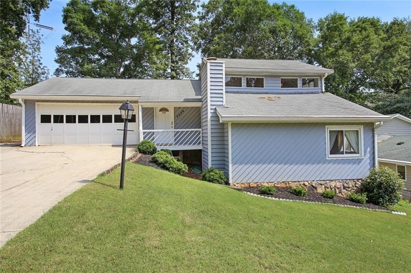 Welcome home!  Cute front porch and beautiful lawn