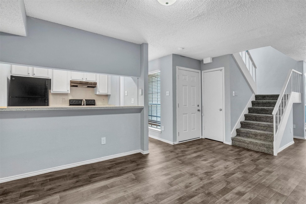 Kitchen with white cabinets and pass through bar a
