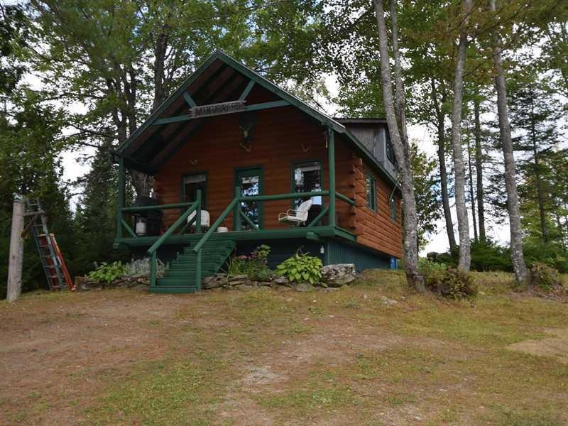 Exterior Front. 1997 Log sided...