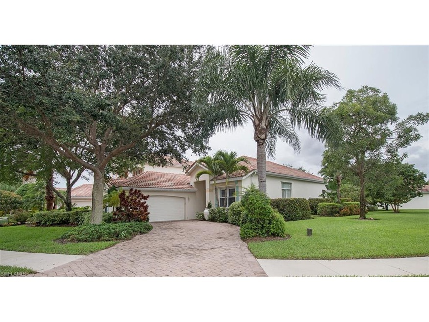 Lots of curb appeal with lush landscaping, brick p