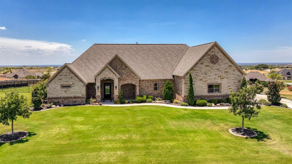 Front Elevation showcasing the fully sodded and irrigated lot, beautiful landscaping including curb and rocked flower beds.