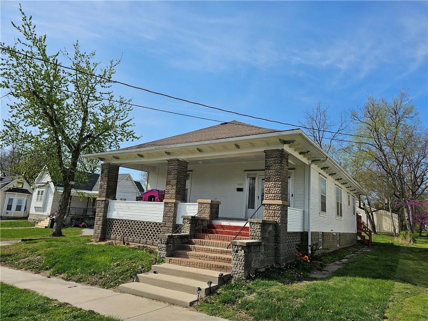 View of front covered porch and a front yard
