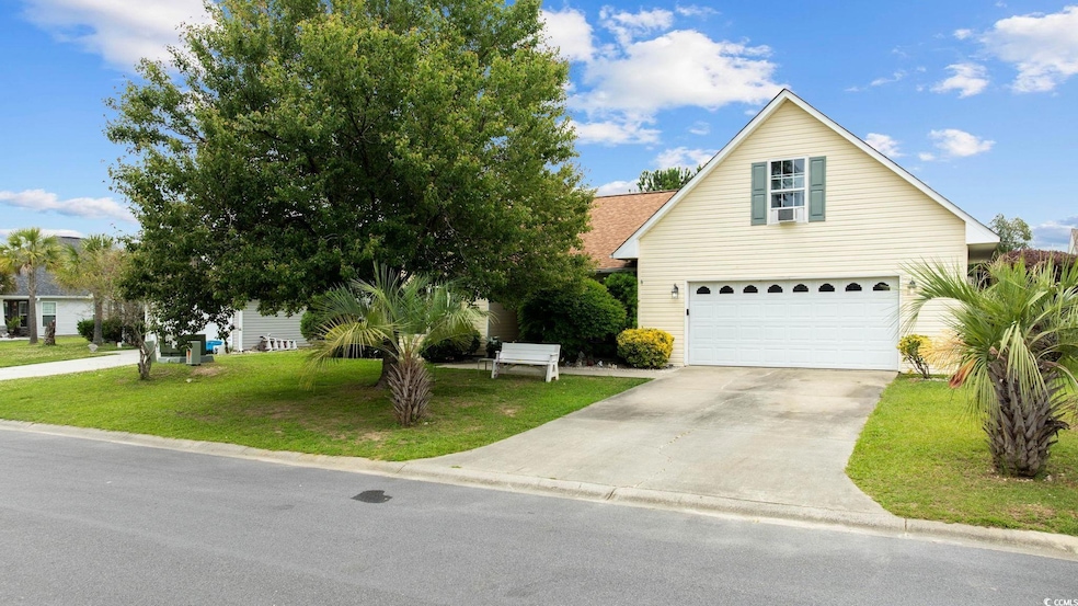 View of front of home featuring concrete driveway, an attached garage, and a front yard