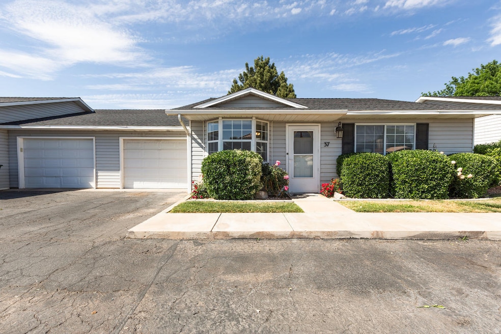 Ranch-style home with asphalt driveway, a shingled roof, and a garage
